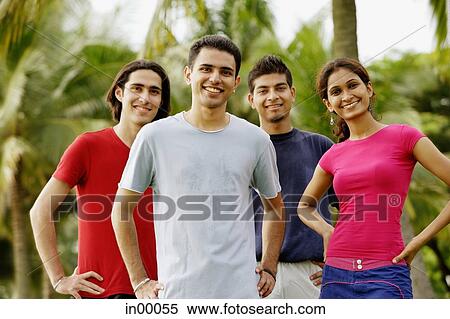 Young adults standing in park, looking at camera View Large Photo Image Stock Photography - Young adults standing in park, looking at camera. Fotosearch
