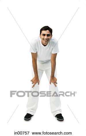 Stock Photo - Young man bending, leaning on knee. Fotosearch