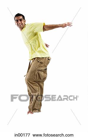 Young man jumping, arms outstretched View Large Photo Image Stock Photo - Young man jumping, arms outstretched. Fotosearch