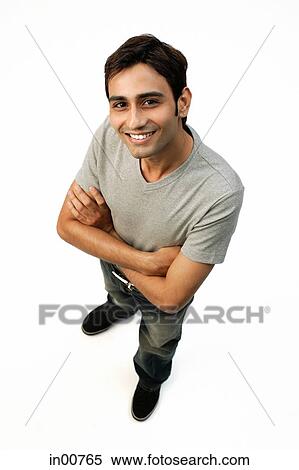 Young man looking at camera, arms crossed View Large Photo Image Stock Photography - Young man looking at camera, arms crossed. Fotosearch