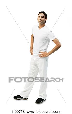Young man looking at camera, hands on hips View Large Photo Image Stock Photo - Young man looking at camera, hands on hips. Fotosearch