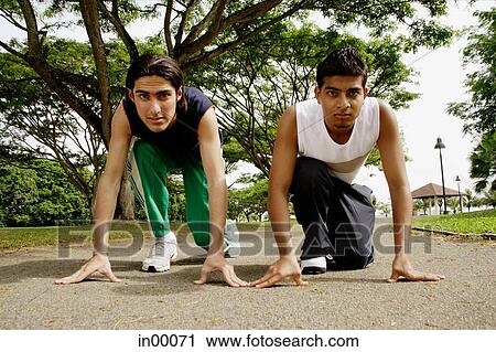 Young men in starting position View Large Photo Image Stock Image - Young men in starting position. Fotosearch