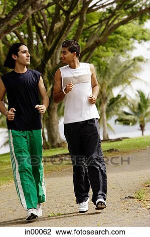 Young men jogging in park View Large Photo Image Stock Image - Young men jogging in park. Fotosearch