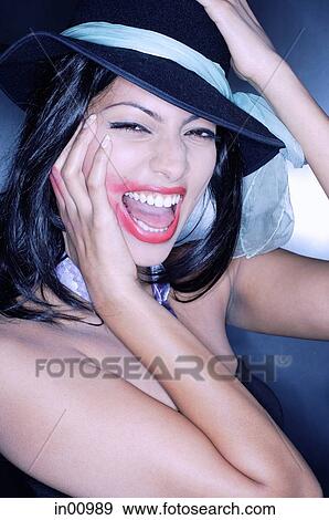 Young woman, hand on face, mouth open, lipstick smeared View Large Photo Image Stock Photo - Young woman, hand on face, mouth open, lipstick smeared. Fotosearch