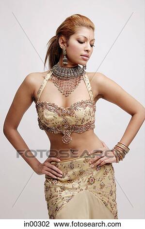 Young woman in Indian costume, hands on hips, looking down View Large Photo Image Stock Image - Young woman in Indian costume, hands on hips, looking down. Fotosearch