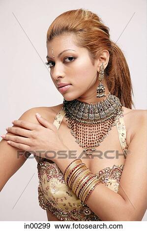 Young woman in Indian costume, looking at camera, hand on shoulder View Large Photo Image Stock Photo - Young woman in Indian costume, looking at camera, hand on shoulder. Fotosearch