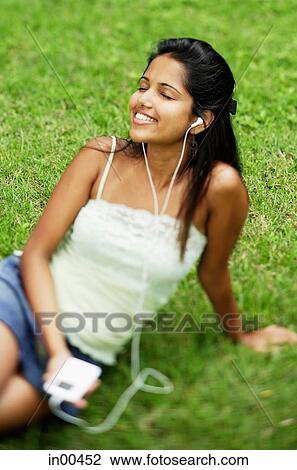 Young woman listening to music with headphones View Large Photo Image Stock Image - Young woman listening to music with headphones. Fotosearch