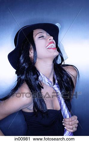 Young woman, wearing hat and tie, laughing View Large Photo Image Stock Image - Young woman, wearing hat and tie, laughing. Fotosearch