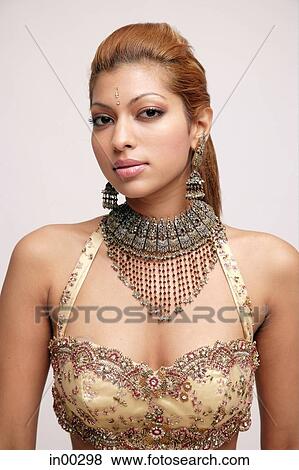 Young woman with Indian costume and jewellery, looking at camera View Large Photo Image Stock Photo - Young woman with Indian costume and jewellery, looking at camera. Fotosearch