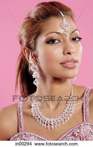 Young woman with Indian jewellery, looking at camera, head shot View Large Photo Image Picture - Young woman with Indian jewellery, looking at camera, head shot. Fotosearch