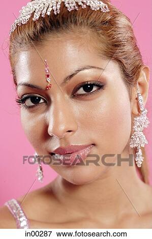 Young woman with Indian jewellery, looking at camera, head shot View Large Photo Image Stock Photo - Young woman with Indian jewellery, looking at camera, head shot. Fotosearch