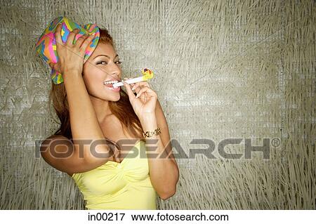 Young woman with party hat and noisemaker View Large Photo Image Stock Photo - Young woman with party hat and noisemaker. Fotosearch