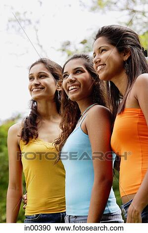 Young women standing in a row, looking away View Large Photo Image Stock Image - Young women standing in a row, looking away. Fotosearch