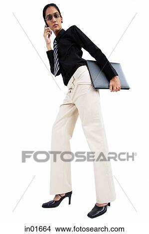 Business woman using mobile phone, low angle view View Large Photo Image Picture - Business woman using mobile phone, low angle view. Fotosearch