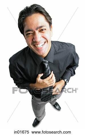 Businessman smiling at camera, high angle view View Large Photo Image Stock Photography - Businessman smiling at camera, high angle view. Fotosearch