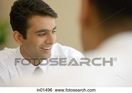 Stock Photograph - Businessman smiling, looking away. Fotosearch
