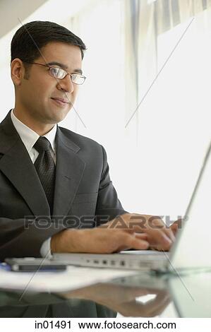 Businessman using laptop View Large Photo Image Stock Image - Businessman using laptop. Fotosearch