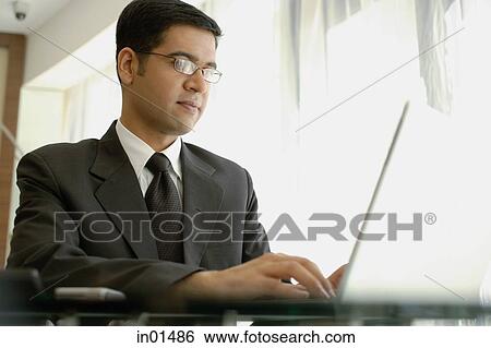 Stock Photograph - Businessman using laptop. Fotosearch