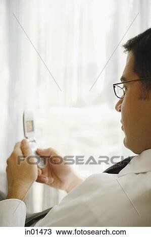 Stock Image - Businessman using mobile phone. Fotosearch