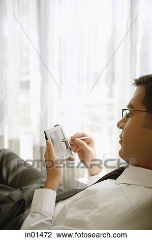 Businessman using PDA View Large Photo Image Stock Image - Businessman using PDA. Fotosearch