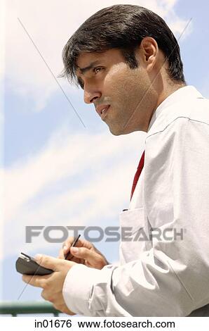 Businessman using PDA View Large Photo Image Stock Photograph - Businessman using PDA. Fotosearch