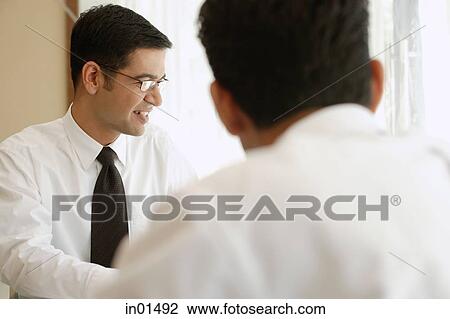 Businessmen looking away, over the shoulder view View Large Photo Image Stock Image - Businessmen looking away, over the shoulder view. Fotosearch