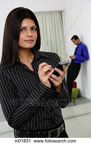 Businesswoman with PDA, looking at camera View Large Photo Image Stock Image - Businesswoman with PDA, looking at camera. Fotosearch