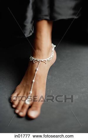 Close-up of woman's feet with traditional Indian toe ring and anklet View Large Photo Image Stock Photo - Close-up of woman's feet with traditional Indian toe ring and anklet. Fotosearch
