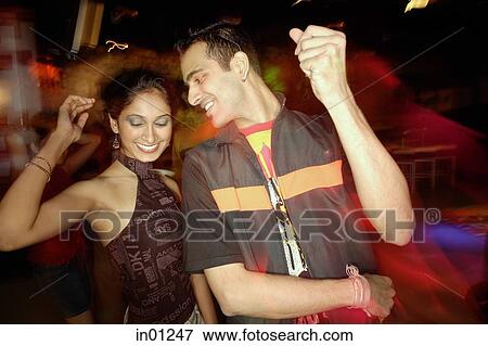 Couple dancing in night club View Large Photo Image Stock Photo - Couple dancing in night club. Fotosearch