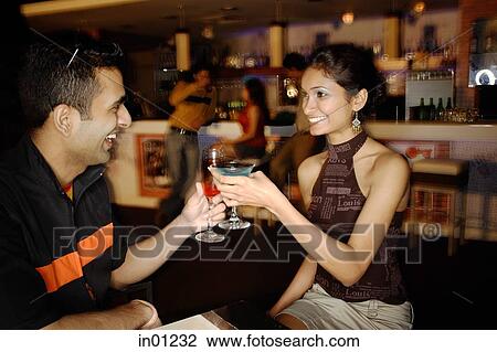 Couple in a club, toasting with cocktails View Large Photo Image Stock Image - Couple in a club, toasting with cocktails. Fotosearch