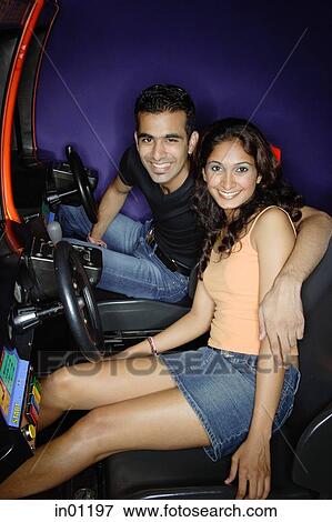 Couple in a video game arcade, smiling at camera View Large Photo Image Stock Photo - Couple in a video game arcade, smiling at camera. Fotosearch