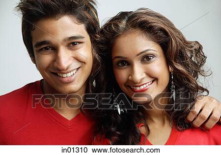 Stock Image - Couple looking at camera, smiling. Fotosearch