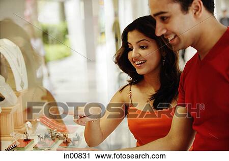 Couple looking at jewellery display in shop window View Large Photo Image Stock Image - Couple looking at jewellery display in shop window. Fotosearch