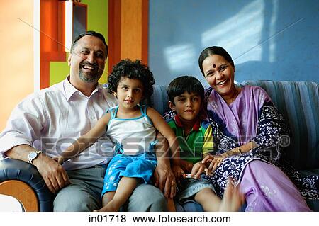 Family with two children, smiling at camera View Large Photo Image Stock Photo - Family with two children, smiling at camera. Fotosearch