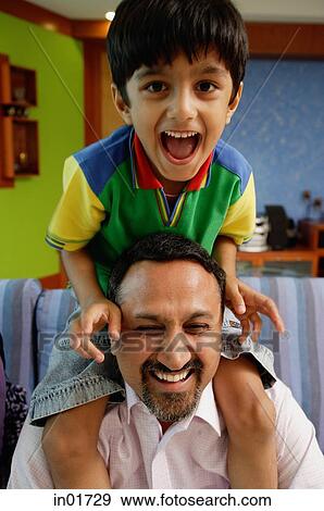 Stock Photo - Father carrying son on shoulders. Fotosearch