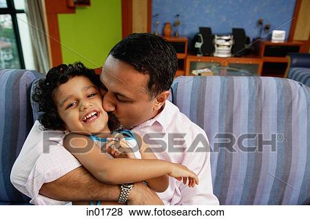 Father embracing daughter, kissing her on cheek View Large Photo Image Stock Photo - Father embracing daughter, kissing her on cheek. Fotosearch