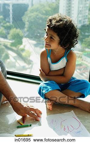Girl sitting on floor looking away, fathers hands in foreground View Large Photo Image Stock Photography - Girl sitting on floor looking away, fathers hands in foreground. Fotosearch