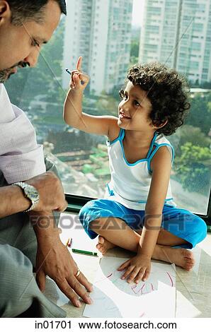 Girl sitting on floor with crayons and paper, looking at father next to her View Large Photo Image Stock Image - Girl sitting on floor with crayons and paper, looking at father next to her. Fotosearch