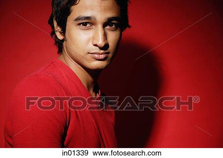 Stock Photo - Man in red shirt against red background. Fotosearch