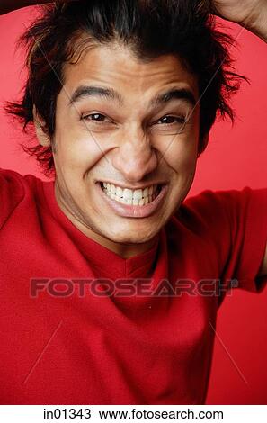 Man in red T-shirt against red background, making a face View Large Photo Image Stock Image - Man in red T-shirt against red background, making a face. Fotosearch