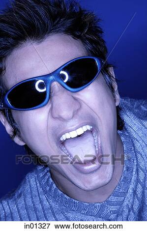 Man in sunglasses, shouting, tinted image View Large Photo Image Stock Photo - Man in sunglasses, shouting, tinted image. Fotosearch