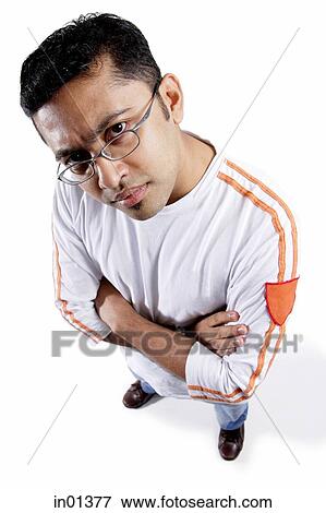 Man looking at camera, arms crossed, frowning View Large Photo Image Stock Photo - Man looking at camera, arms crossed, frowning. Fotosearch