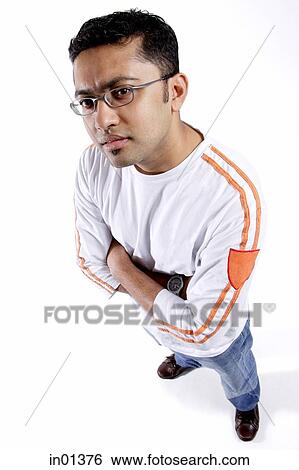 Man looking at camera, arms crossed View Large Photo Image Stock Photograph - Man looking at camera, arms crossed. Fotosearch