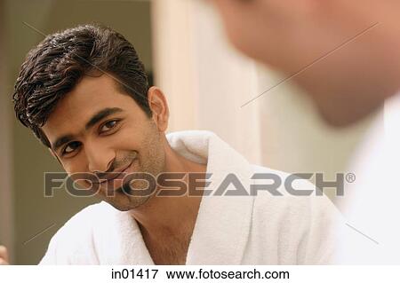 Man looking at his reflection in mirror, smiling View Large Photo Image Stock Photo - Man looking at his reflection in mirror, smiling. Fotosearch