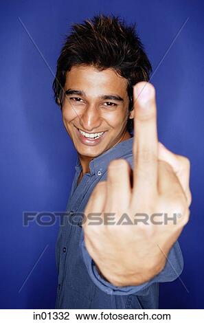 Man smiling at camera, making a hand sign with finger View Large Photo Image Stock Image - Man smiling at camera, making a hand sign with finger. Fotosearch