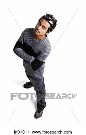 Man standing with arms crossed, looking up at camera View Large Photo Image Stock Photo - Man standing with arms crossed, looking up at camera. Fotosearch