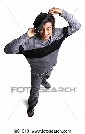 Stock Photo - Man with hat looking up at camera. Fotosearch