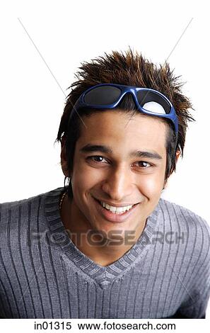 Man with sunglasses on head, smiling at camera View Large Photo Image Stock Photography - Man with sunglasses on head, smiling at camera. Fotosearch