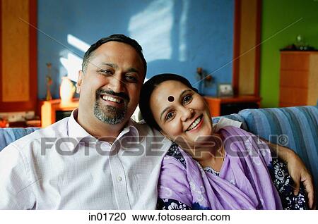 Mature couple sitting side by side, smiling at camera, portrait View Large Photo Image Stock Image - Mature couple sitting side by side, smiling at camera, portrait. Fotosearch