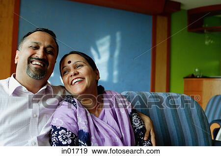 Mature couple sitting side by side, smiling View Large Photo Image Stock Photo - Mature couple sitting side by side, smiling. Fotosearch